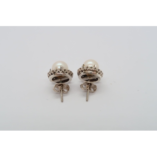 59 - An 18ct white gold pearl and diamond earrings, head size approx 12mm diameter, pearls approx 8mm dia... 