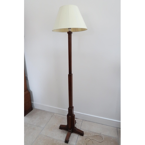 632 - An Art Deco oak standard lamp and shade in working order