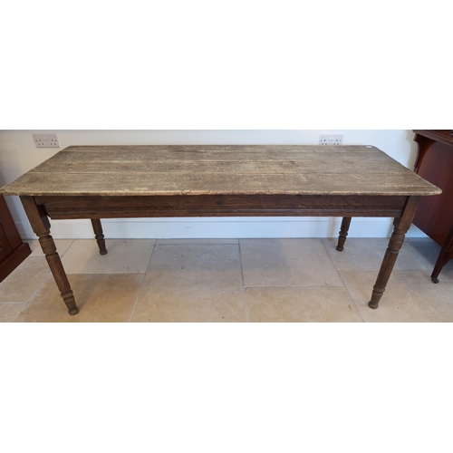 634 - A rustic pine table on turned legs, 182cm long x 72cm wide