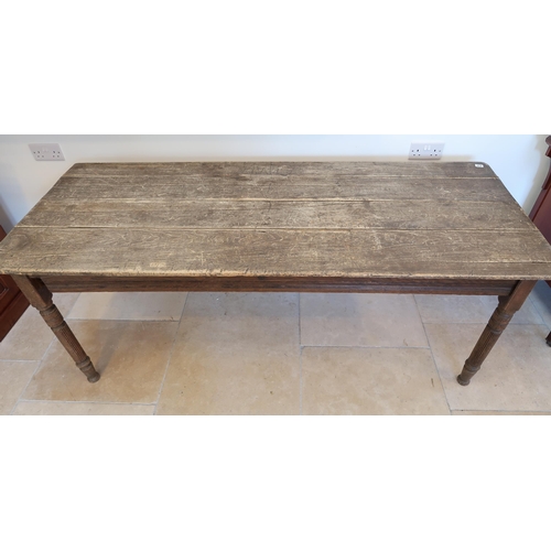 634 - A rustic pine table on turned legs, 182cm long x 72cm wide