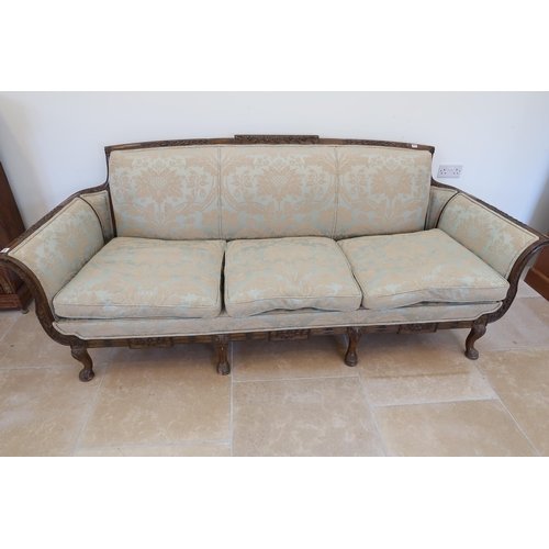 650 - A large carved mahogany settee raised on four cabriole legs, 238cm wide