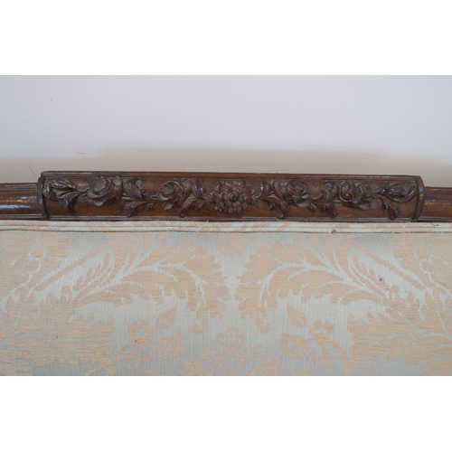 650 - A large carved mahogany settee raised on four cabriole legs, 238cm wide