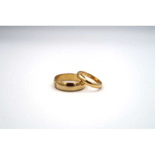 93 - An 18ct yellow gold wedding band ring, size G, approx 2 grams together with a gold plated ring, size... 