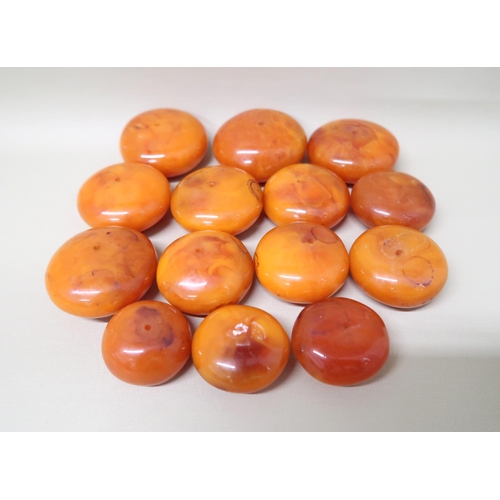 97 - A graduated set of 14 butterscotch Amber beads of circular form ranging from 3.2cm x 2cm to 6cm x 3c... 