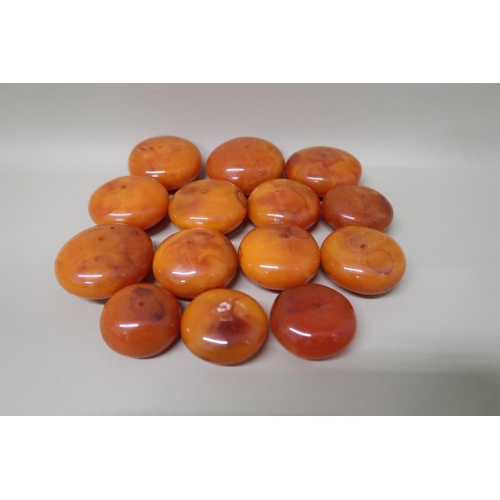 97 - A graduated set of 14 butterscotch Amber beads of circular form ranging from 3.2cm x 2cm to 6cm x 3c... 