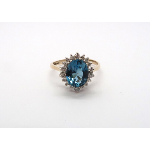 99 - A 9ct yellow gold blue topaz and diamond ring, topaz is a good colour, diamonds bright and lively, h... 