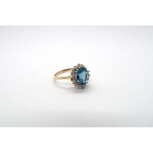 99 - A 9ct yellow gold blue topaz and diamond ring, topaz is a good colour, diamonds bright and lively, h... 