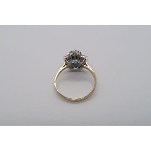 99 - A 9ct yellow gold blue topaz and diamond ring, topaz is a good colour, diamonds bright and lively, h... 