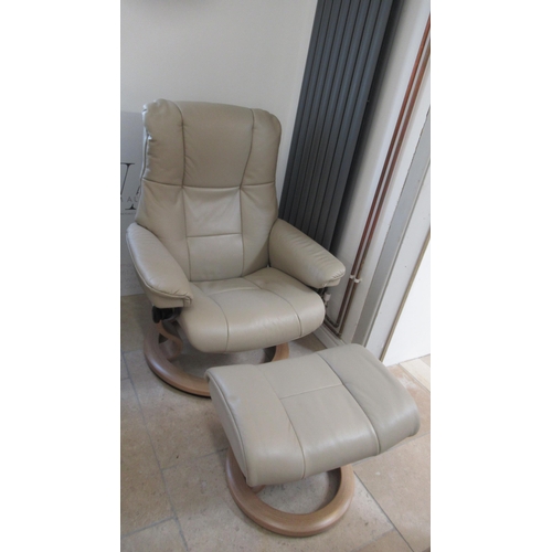 679 - A Stressless Mayfair medium chair and stool, oak frame, with beige leather upholstery