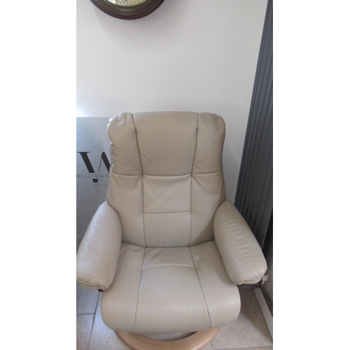 679 - A Stressless Mayfair medium chair and stool, oak frame, with beige leather upholstery