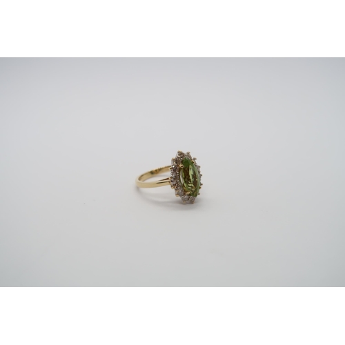 99 - An 18ct yellow gold marquis cut peridot and diamond ring, peridot is good colour, diamonds bright an... 