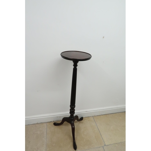 653 - A mahogany torchere /jardiniere stand with turned and fluted column on tripod legs - Height 112cm