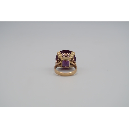 10 - A single purple stone ring. Believed to be synthetic sapphire. Stamped 585. Size P 1/2. Weight appro... 