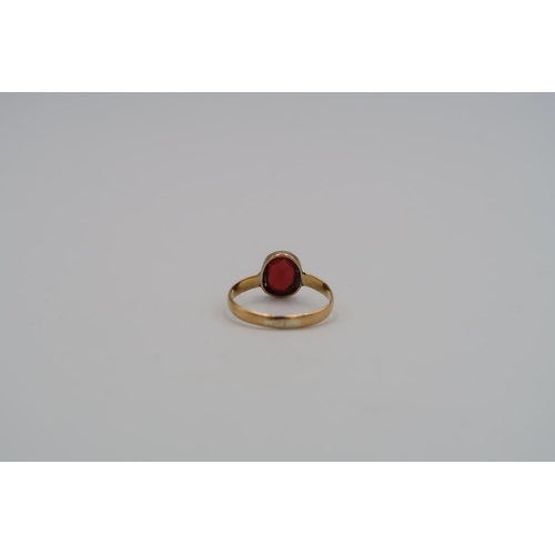 11 - A 22ct yellow gold ring with oval cut garnet to shoulder - weight approx 1.94 grams - ring size N