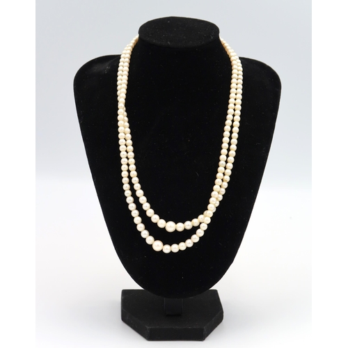 110 - A graduated pearl necklace with 9ct gold foliate design pendant and 9ct clasp, approx 80cm long