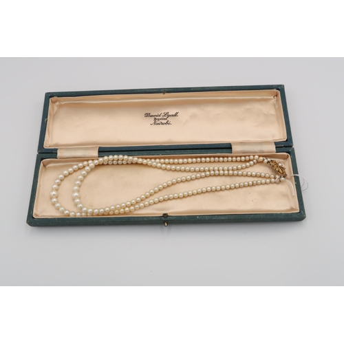 110 - A graduated pearl necklace with 9ct gold foliate design pendant and 9ct clasp, approx 80cm long