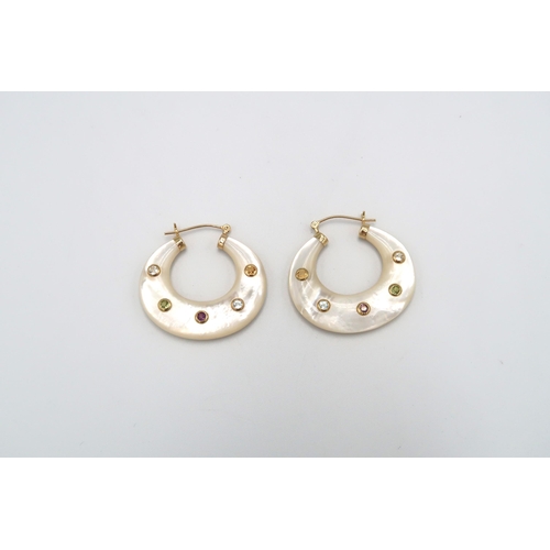 114 - A pair of mother of pearl crescent hoop earrings, each inlaid with five stone collets. Length 32mm, ... 