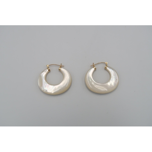 114 - A pair of mother of pearl crescent hoop earrings, each inlaid with five stone collets. Length 32mm, ... 