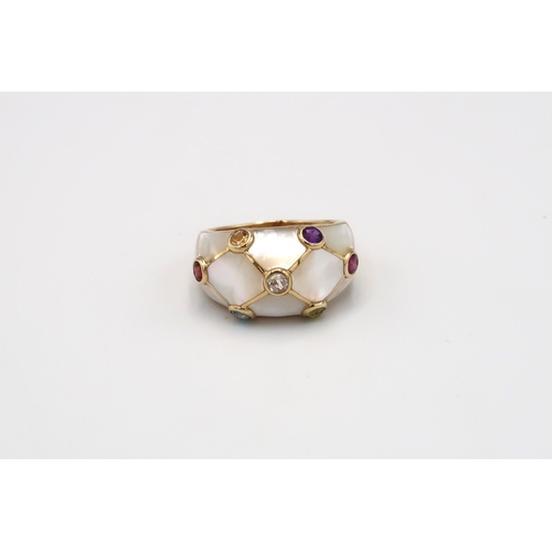 115 - A mother of pearl bombe style ring with seven stone collets. Stamped 14K. Size U. Weight 6.18 grams.