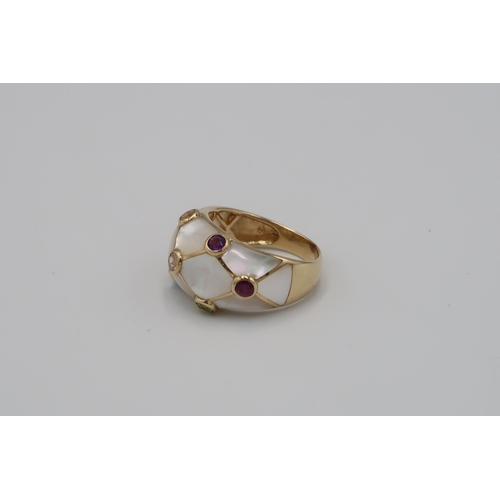 115 - A mother of pearl bombe style ring with seven stone collets. Stamped 14K. Size U. Weight 6.18 grams.