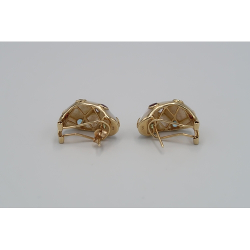 118 - A pair of mother of pearl ear cuffs. Each with seven stone collets. Length 23mm. Weight 7.79 grams.