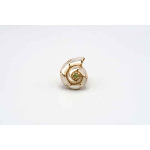 119 - A ring in the form of a mother of pearl conch shell, with green central stone. Stamped 585. Ring siz... 