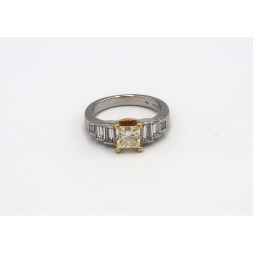 124 - An 18ct gold and platinum ring designed as a fancy light yellow princess cut diamond with three grad... 