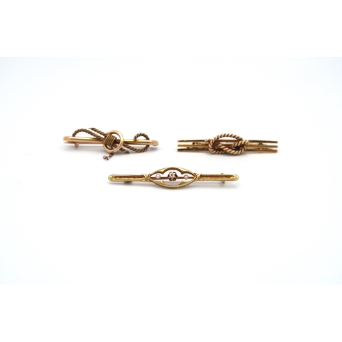 126 - Three bar brooches, one set with a diamond and seed pearls. Stamped 15ct. Weight approx 10.40 grams