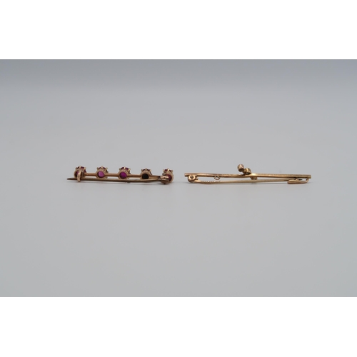 127 - Two bar brooches - one set with five rubies, metal pin, tests 18ct gold. Weight approx 2.73 grams. O... 