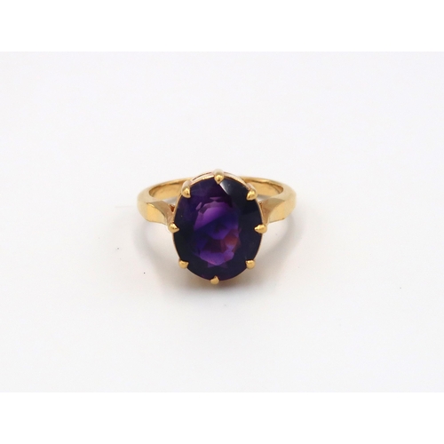 132 - A 22ct Indian gold ring, oval cut amethyst to shoulder - total weight approx 7.19 grams. Size O 1/2