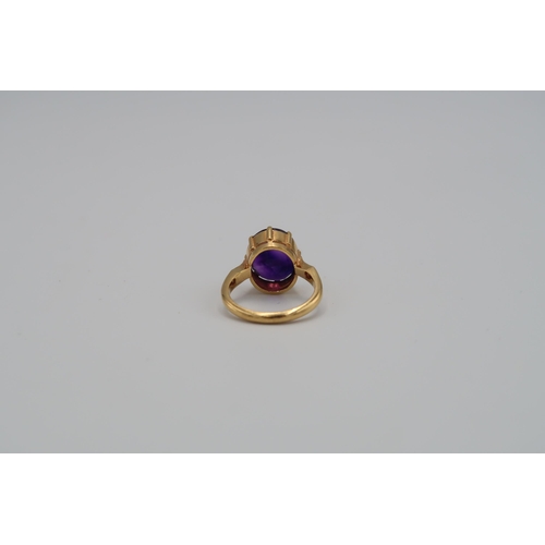 132 - A 22ct Indian gold ring, oval cut amethyst to shoulder - total weight approx 7.19 grams. Size O 1/2