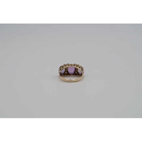 142 - A 9ct gold three stone ring set with amethysts - ring size N - weight approx 3.84 grams