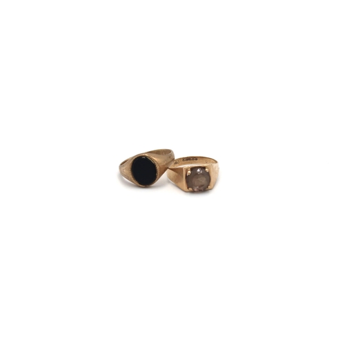 145 - Two 9ct gold rings to include and oval onyx signet ring and a smokey quartz single stone. Size P1/2 ... 