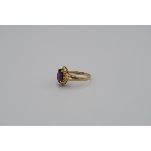 18 - An oval purple single stone ring. Stone setting requires tightening. Size S 1/2. Stamped 585. Weight... 