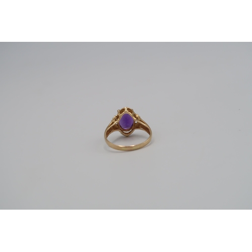 18 - An oval purple single stone ring. Stone setting requires tightening. Size S 1/2. Stamped 585. Weight... 