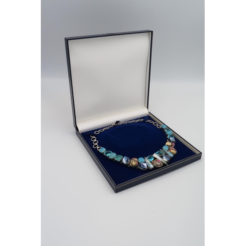 182 - A Modernist sterling Silver Blue Zircon and Baroque Pearl and Mixed Stone necklace.