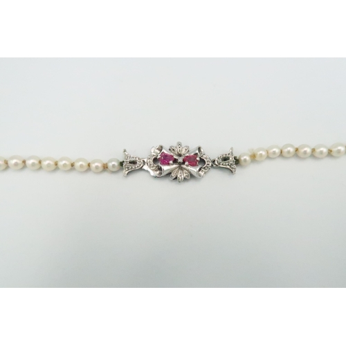 32 - A string of simulated pearls with white metal clasp set with amethysts, approx 5cm long