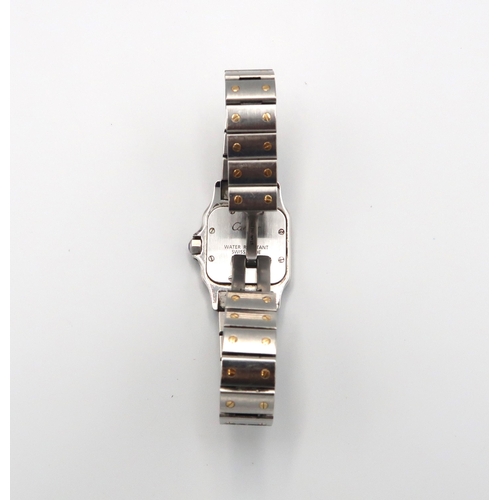 321 - A ladies Cartier Santos 1567. Steel and gold. Good condition, requires a new battery. Weight 64.67