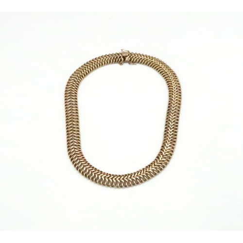 34 - A 9ct gold articulated herringbone link necklace. Length 420mm. Weight approx 63.50 grams.