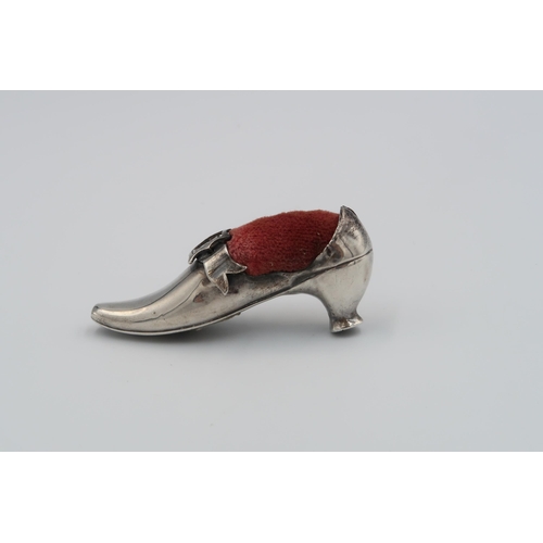 391 - A H.M. Silver pin cushion in the form of a shoe.