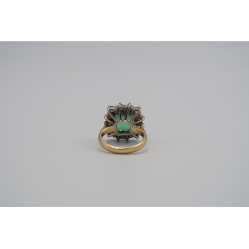 43 - A 18ct yellow gold emerald and diamond cluster ring, the square emerald estimated 5.59cts surrounded... 