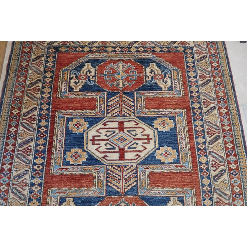 572 - A hand knotted Kazak rug retailed by Fired Earth - 193cm x 170cm