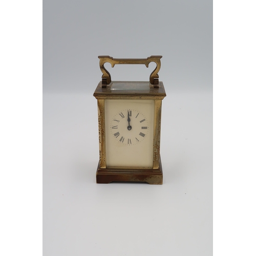 614 - A brass cased carriage clock, ACG to back, with key, Roman numerals to dial, running in saleroom