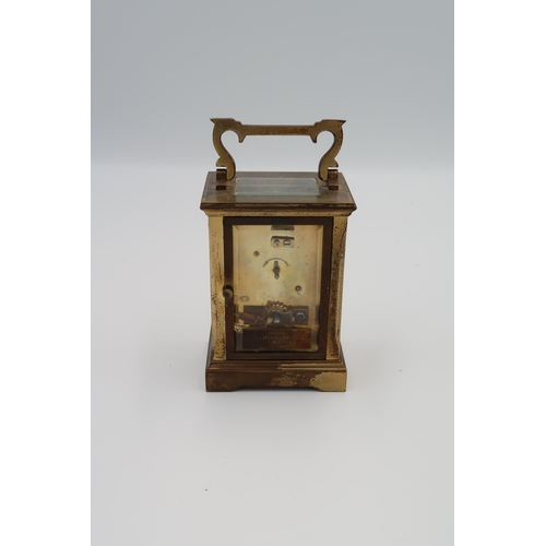 614 - A brass cased carriage clock, ACG to back, with key, Roman numerals to dial, running in saleroom