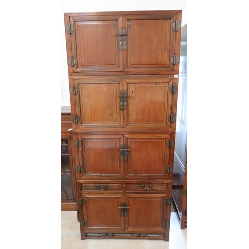 635 - A Chinese hardwood modular cabinet of four sections, each section with two doors, bottom section wit... 