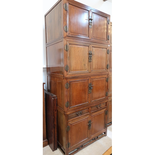 635 - A Chinese hardwood modular cabinet of four sections, each section with two doors, bottom section wit... 