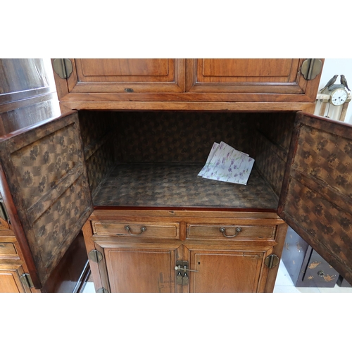 636 - A Chinese hardwood modular cabinet of four sections, each with two doors, the bottom section with tw... 