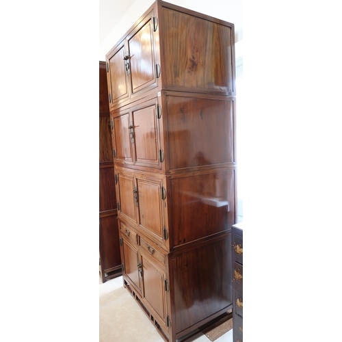 636 - A Chinese hardwood modular cabinet of four sections, each with two doors, the bottom section with tw... 