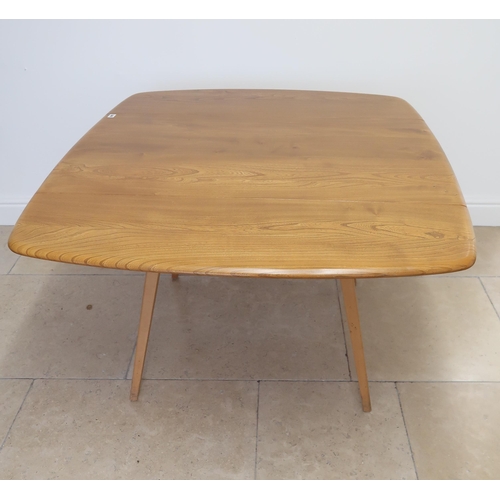 648 - An Ercol blonde elm drop leaf dining table raised on tapering legs with two chairs - 112cm x 123cm x... 