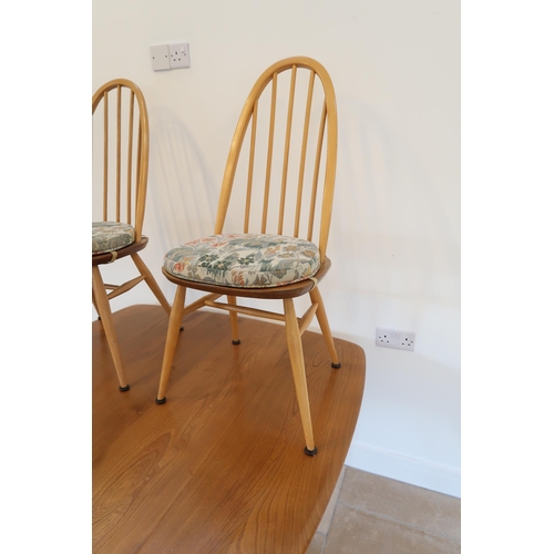 648 - An Ercol blonde elm drop leaf dining table raised on tapering legs with two chairs - 112cm x 123cm x... 